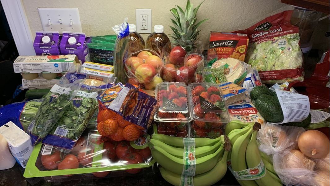 Picture of my counter covered in fruits and vegetables, all purchased for less that $100 dollars.