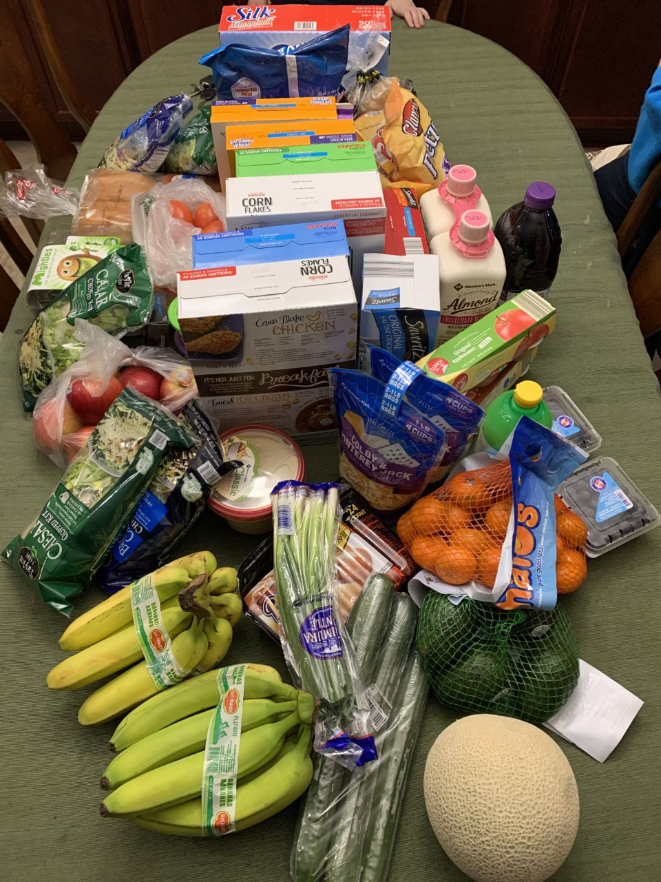Picture of a table full of just bought groceries
